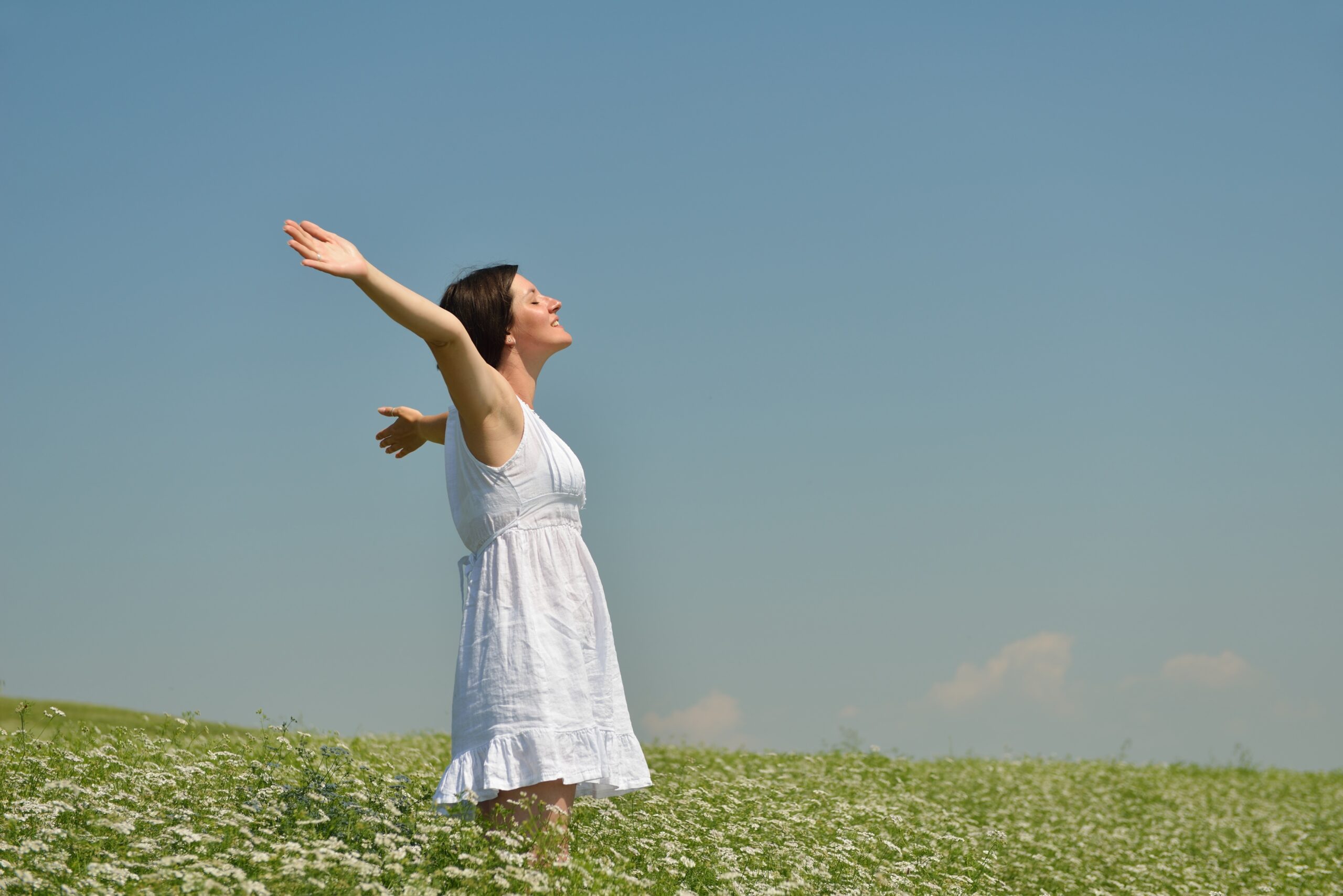 young happy woman in green field
